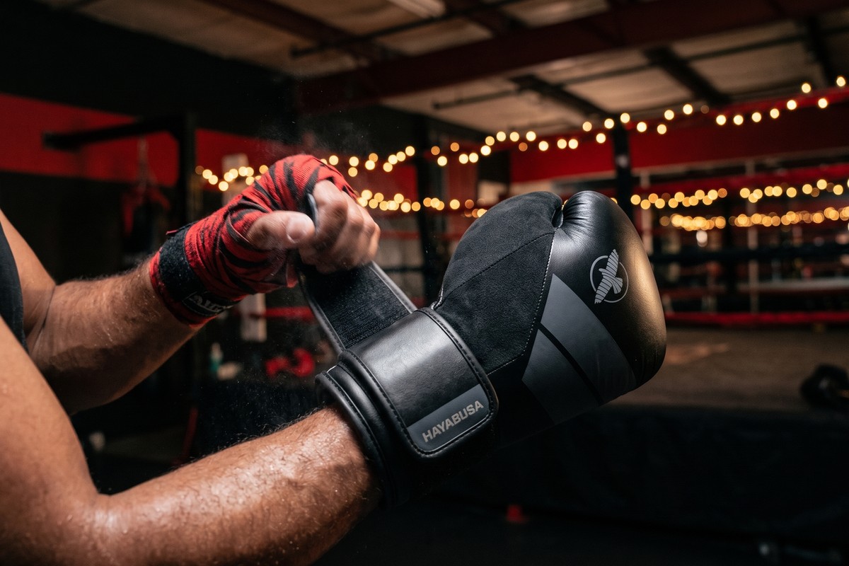 Hand wrapping and putting on Hayabusa S4 boxing gloves before training